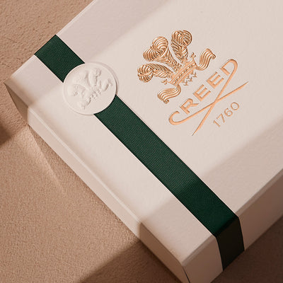 creed gift box with green ribbon