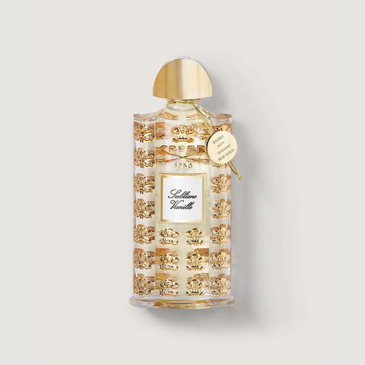 Sublime Vanille 75ml bottle of sublime vanille fragrance with gold cap, gold medallion and repeated pattern of a gold floor de lis on the bottle