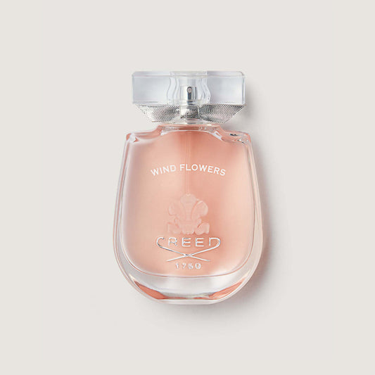 Wind Flowers windflowers bottle with glass stopper showing pink liquid in a curved bottle