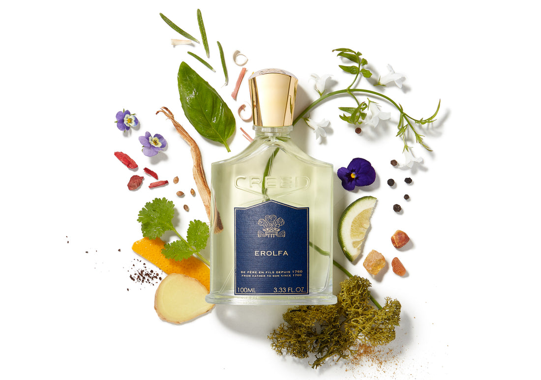 a bottle of erolfa fragrance laying on top of a selection of ingredients