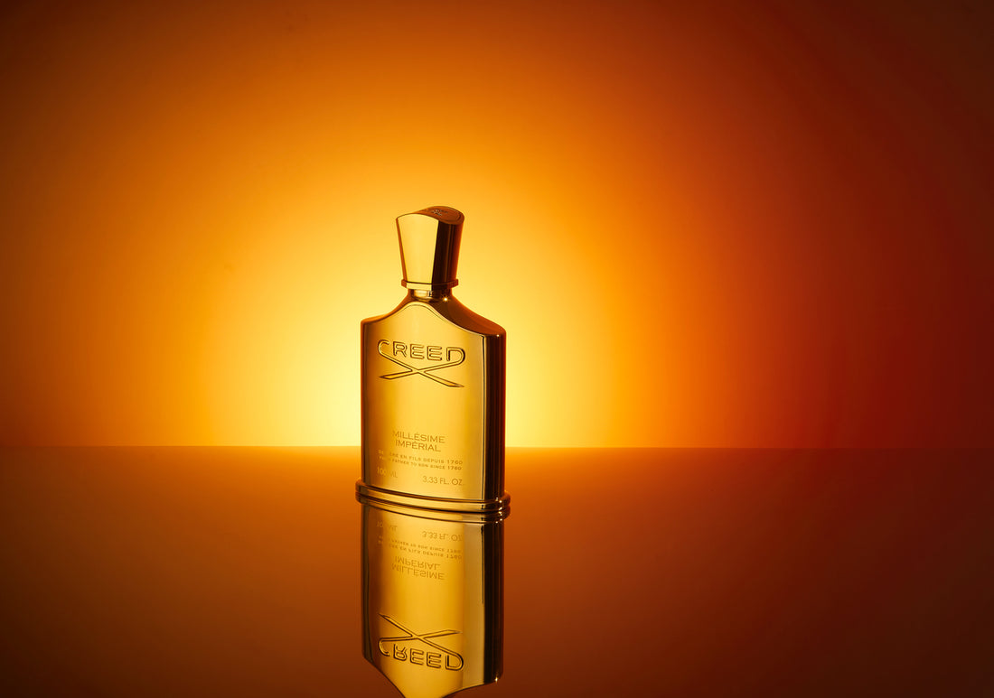 a bottle of Millesime imperial against a background suggesting sunrise