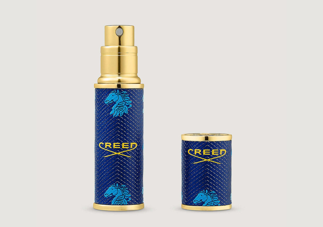 a blue 5ml travel atomise embossed with the creed logo in gold