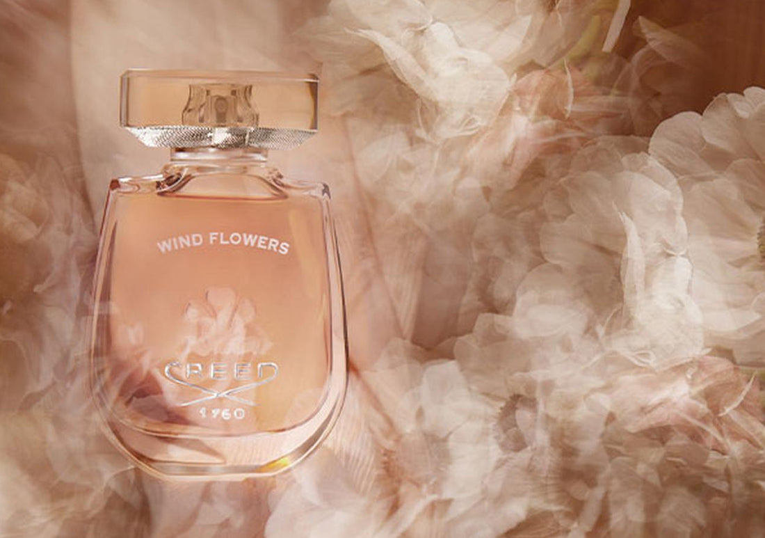 a bottle of wildflowers enveloped in pink smoke