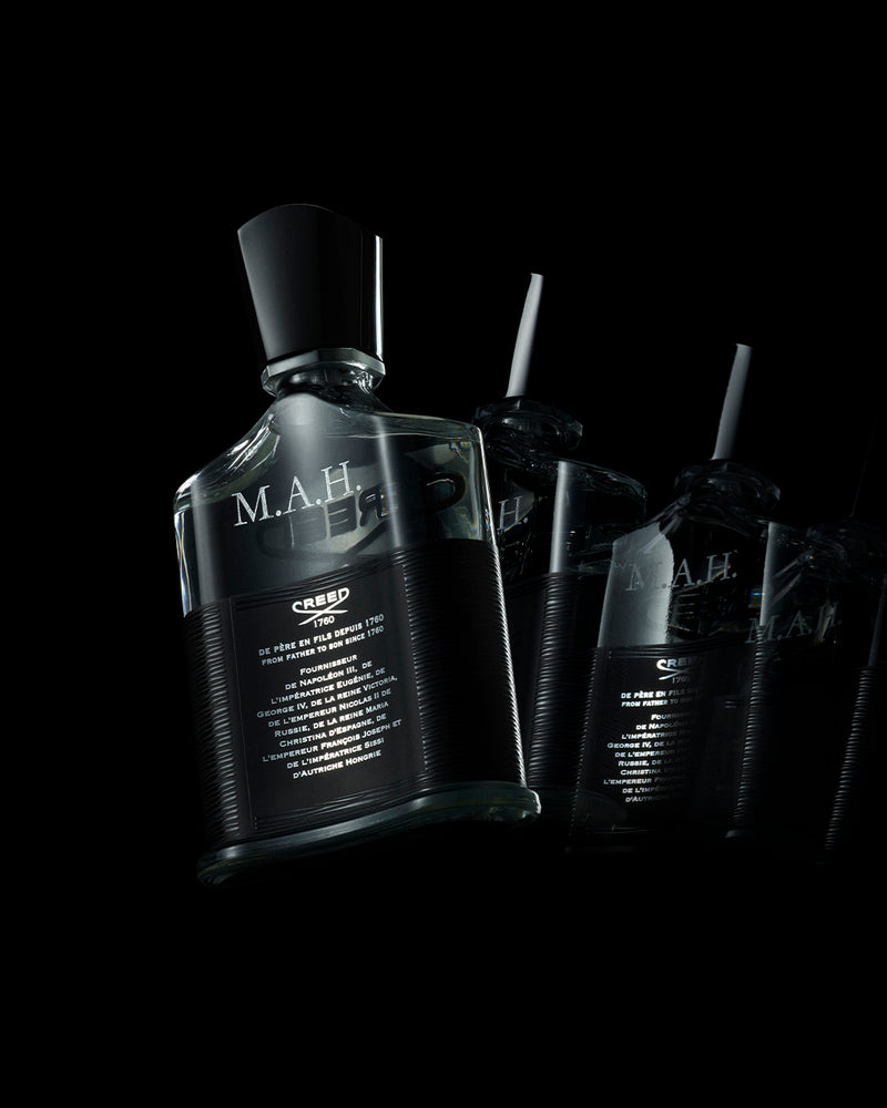 Aventus bottle with engraving on the back with initials MAH on black background