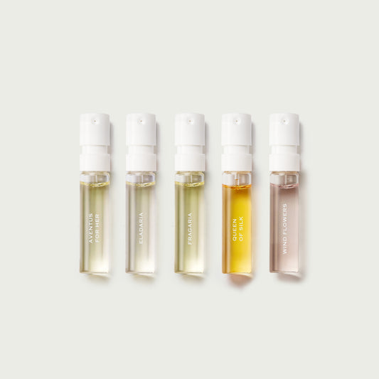 Five skincare serum bottles with visible brand names on a light grey background