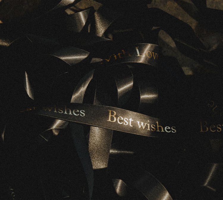 black ribbons printed with a personalised message