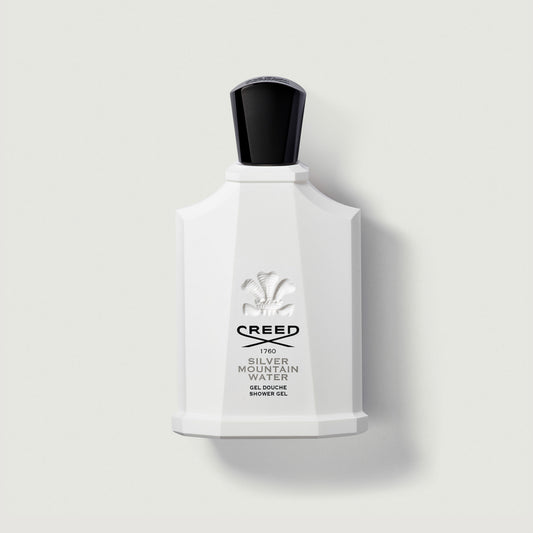 white plastic bottle with black cap labelled silver mountain water with the creed logo