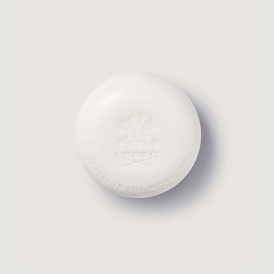 round soap bar with creed logo imprinted on the surface