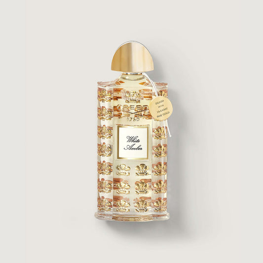 75ml bottle of white amber fragrance with gold medallion and  decorated bottle with embossed gold fleur de lis
